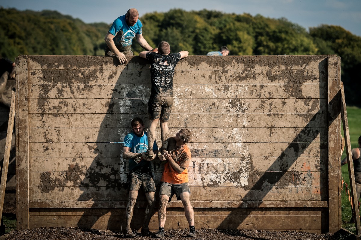 Tough Mudder Teamwork over obstacles